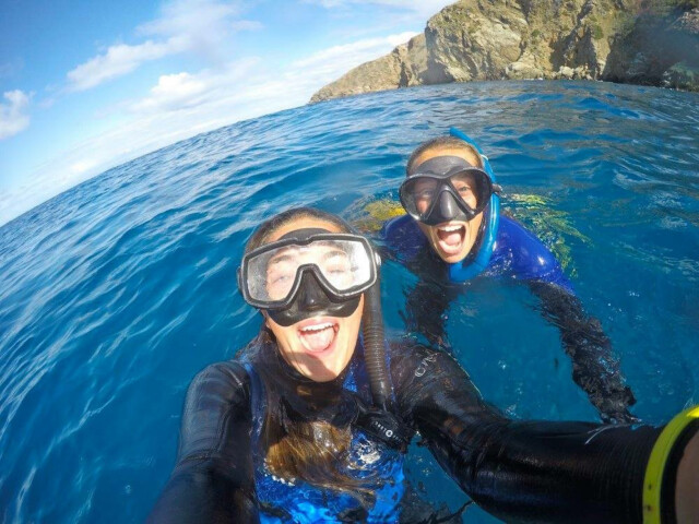 Two people taking selfie in snorkeling gear.