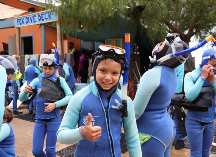Boy smiling thumbs up snorkel gear.