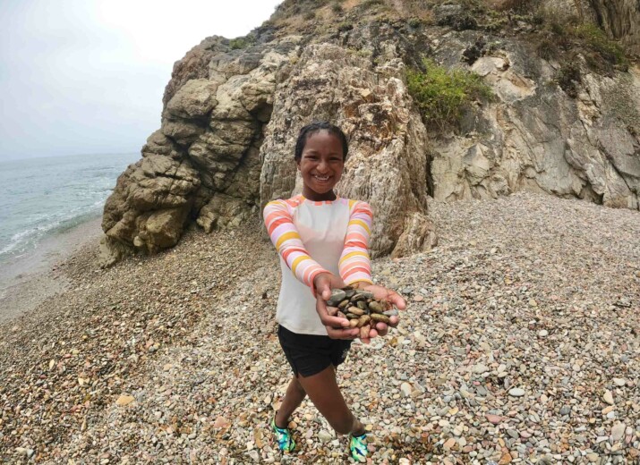 Girl holding rocks.